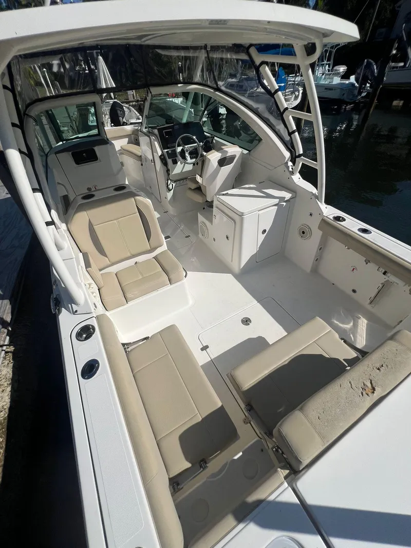Slide: The Image of 2020 Pursuit 266 boat interior with beige seating and modern helm. - 23
