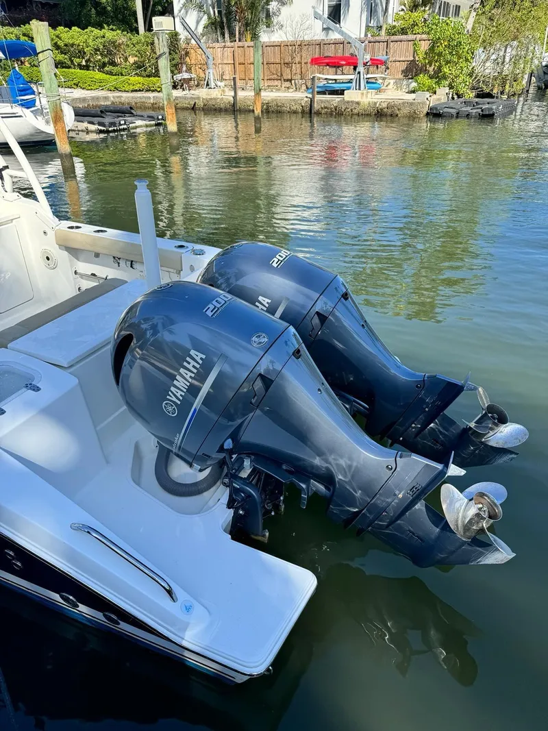 Slide: The Image of 2020 Pursuit 266 boat with twin Yamaha outboard motors docked in a marina. - 8