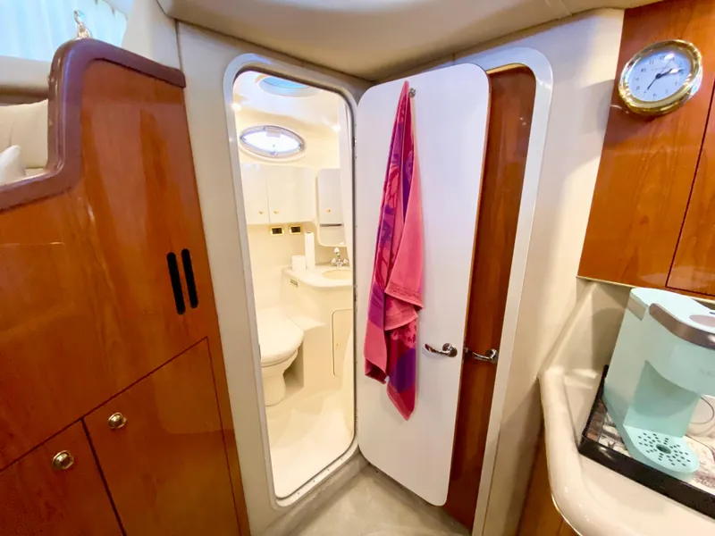 Slide: The Image of 2001 Sea Ray 380 Aft Cabin bathroom with wooden cabinetry and modern fixtures. - 20