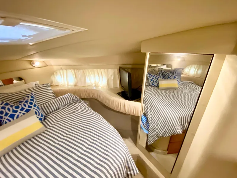 Slide: The Image of Cozy bedroom in 2001 Sea Ray 380 Aft Cabin yacht with striped bedding and mirror. - 25