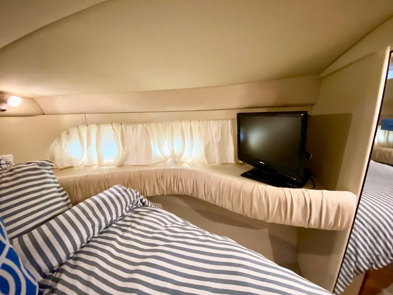 Slide: The Image of Cozy cabin interior of 2001 Sea Ray 380 Aft Cabin with bed and TV. - 26