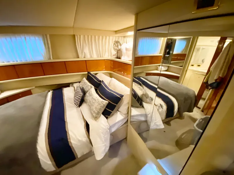 Slide: The Image of Luxurious bedroom in 2001 Sea Ray 380 Aft Cabin yacht with elegant bedding and mirrored closet. - 30