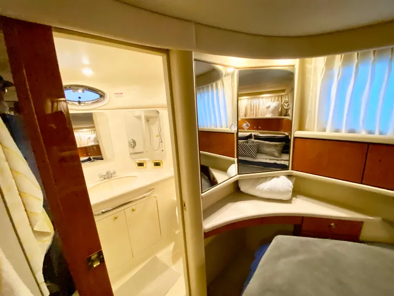 Slide: The Image of Luxurious 2001 Sea Ray 380 Aft Cabin interior with cozy bedroom and bathroom. - 32