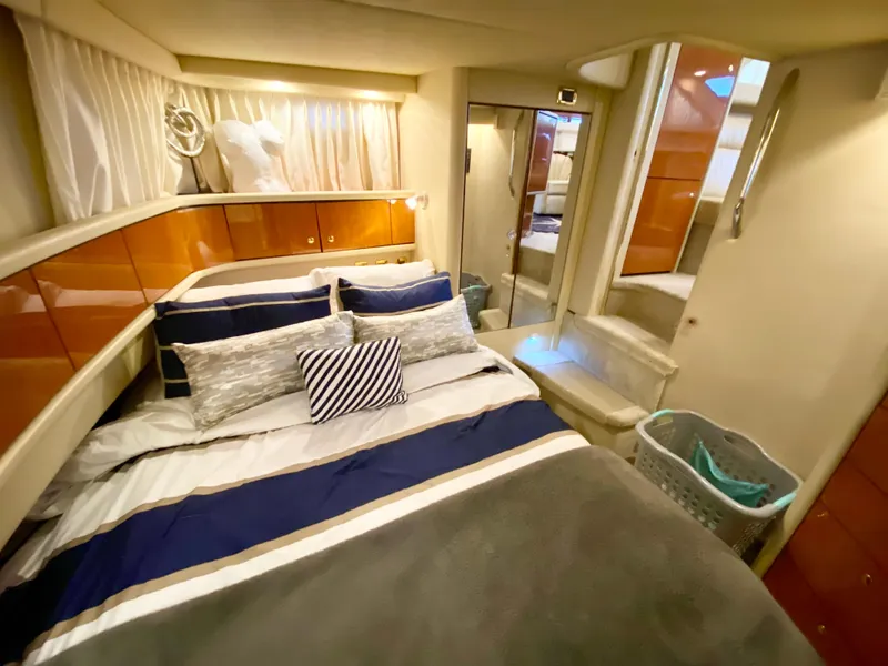 Slide: The Image of Luxurious 2001 Sea Ray 380 Aft Cabin bedroom with elegant bedding and modern decor. - 33