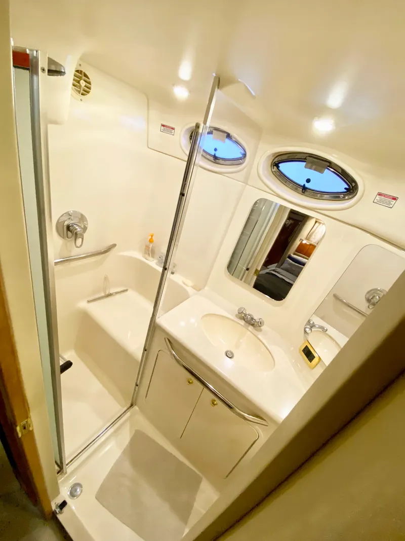 Slide: The Image of 2001 Sea Ray 380 Aft Cabin bathroom with shower, sink, and mirror. - 34