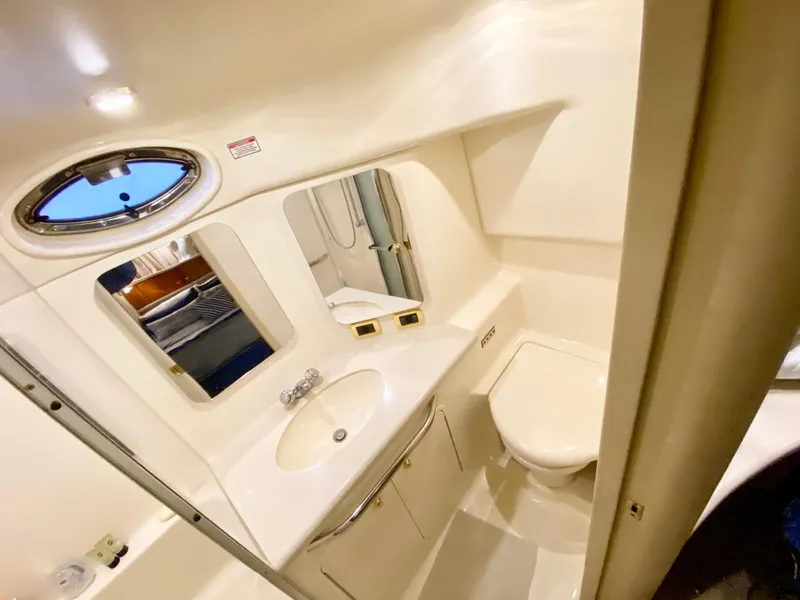 Slide: The Image of 2001 Sea Ray 380 Aft Cabin bathroom with sink, mirror, and toilet. - 35
