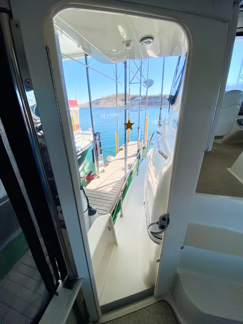 Slide: The Image of View from 2001 Sea Ray 380 Aft Cabin, showing dock and water through cabin door. - 6