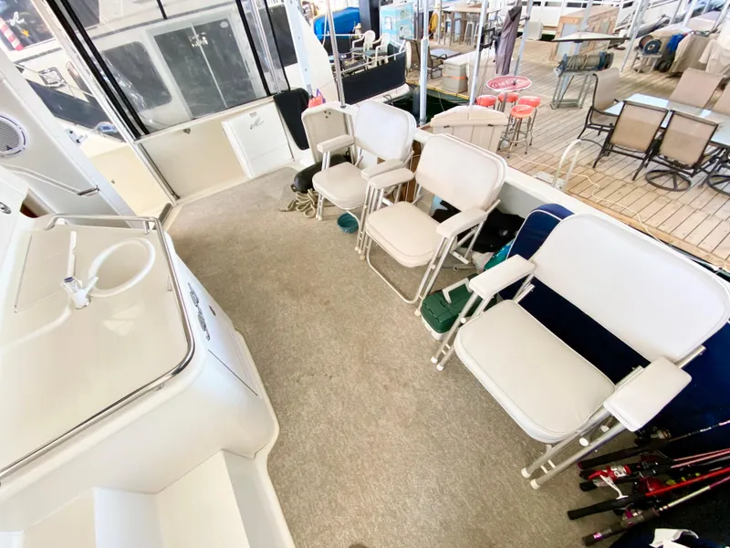 Slide: The Image of 2001 Sea Ray 380 Aft Cabin interior with white chairs and carpeted floor. - 7