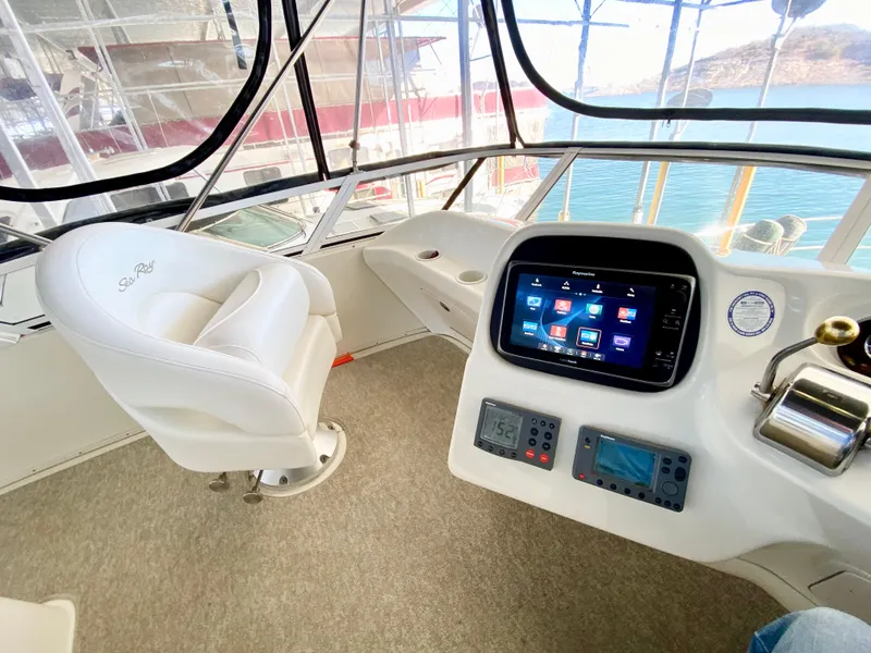 Slide: The Image of 2001 Sea Ray 380 Aft Cabin helm with modern navigation display and white captain's chair. - 9