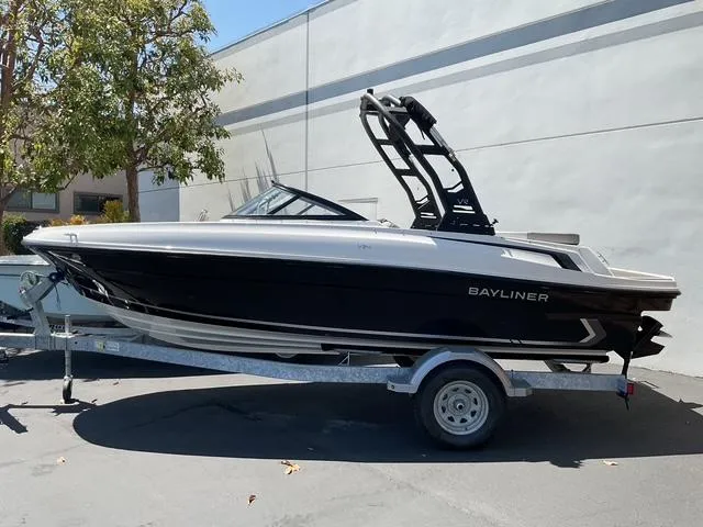 The Image of 2025 Bayliner VR4 Bowrider I/O boat on trailer, parked outdoors. - 0