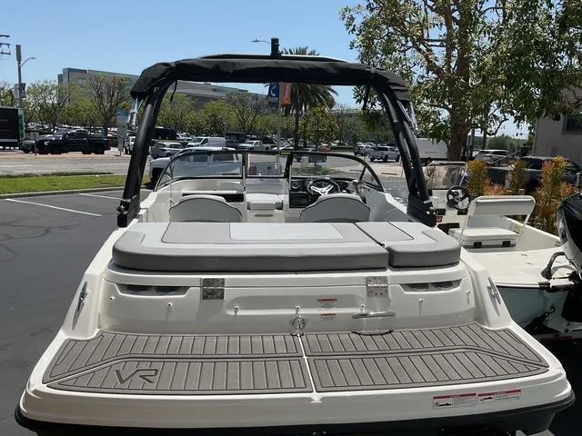 Slide: The Image of 2025 Bayliner VR4 Bowrider I/O boat, rear view, parked outdoors, sunny day. - 10