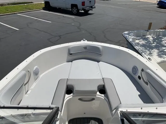 Slide: The Image of 2025 Bayliner VR4 Bowrider I/O boat interior with spacious seating in a parking lot. - 6