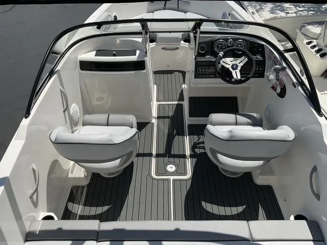 Slide: The Image of 2025 Bayliner VR4 Bowrider I/O interior with dual seats and modern dashboard. - 8