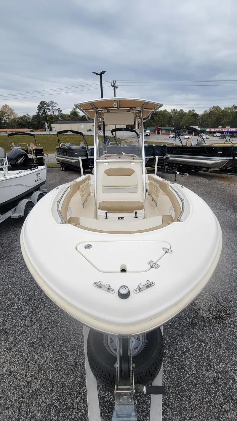 Slide: The Image of 2019 Pioneer 202 Sportfish boat displayed in a parking lot, front view. - 5