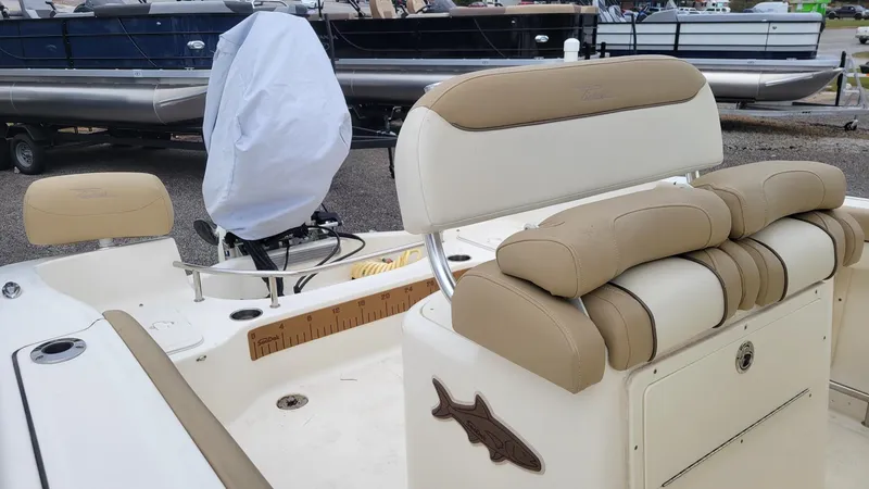 Slide: The Image of 2019 Pioneer 202 Sportfish boat interior with cushioned seating and fishing rod holder. - 7