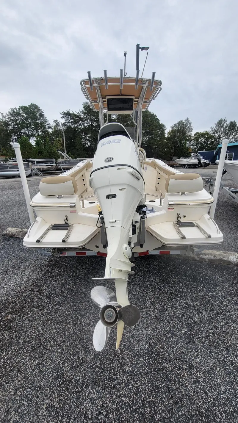 Slide: The Image of 2019 Pioneer 202 Sportfish boat with outboard motor, parked on gravel. - 8