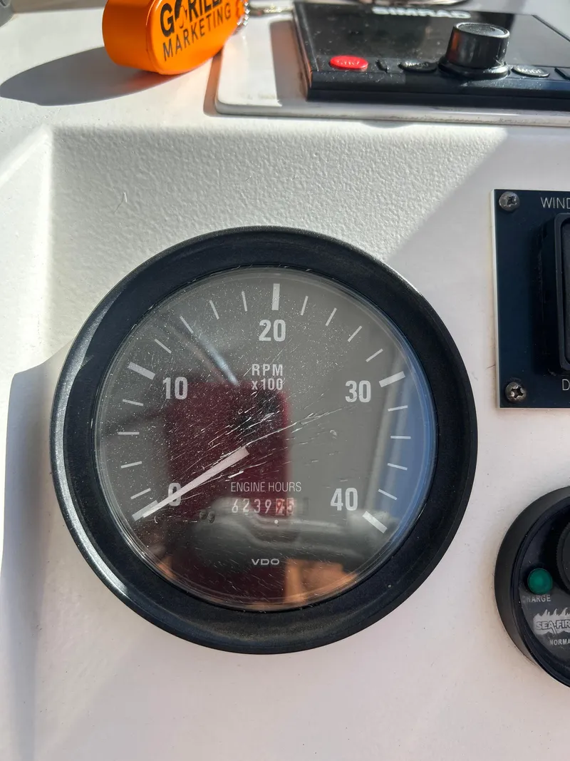 Slide: The Image of Close-up of Mainship Pilot 34 tachometer showing engine hours and RPM. - 10