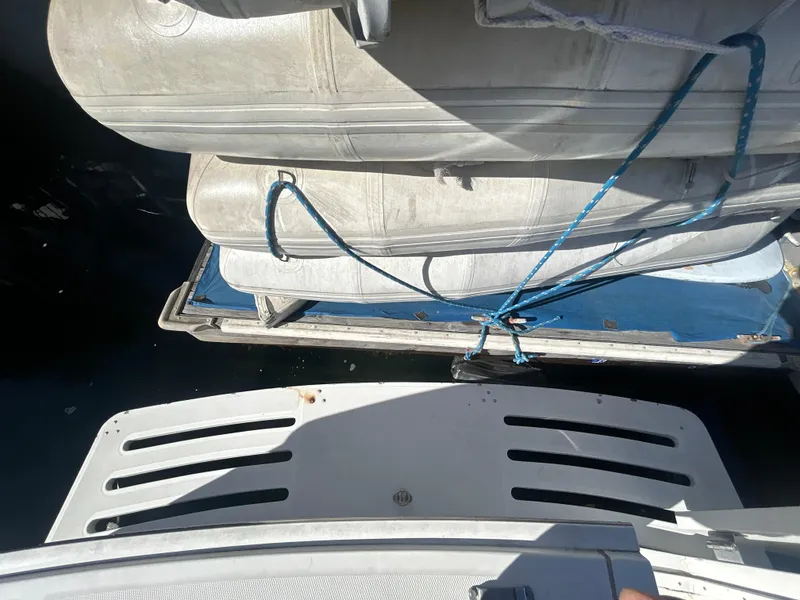 Slide: The Image of 2000 Mainship Pilot 34 with inflatable boat secured on deck. - 14