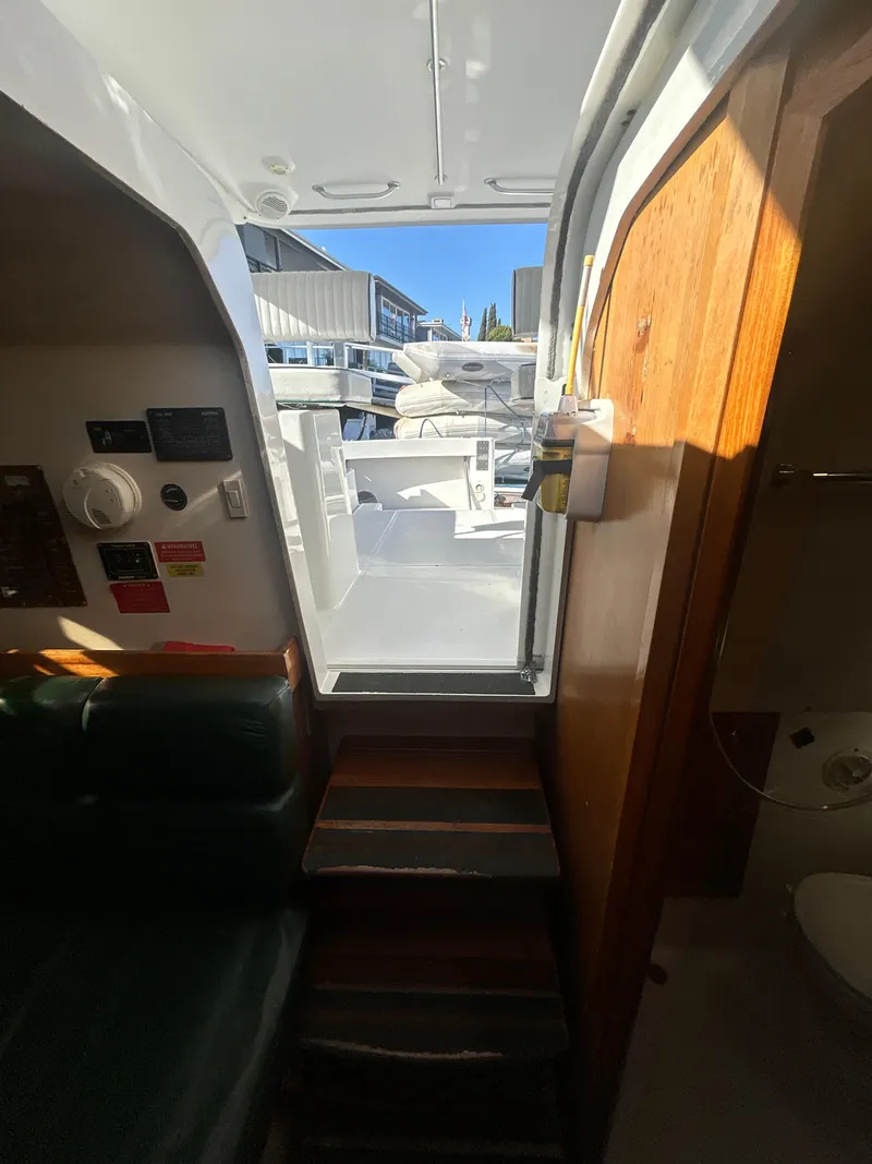 Slide: The Image of Interior view of 2000 Mainship Pilot 34 boat, showing cabin steps and partial bathroom. - 17