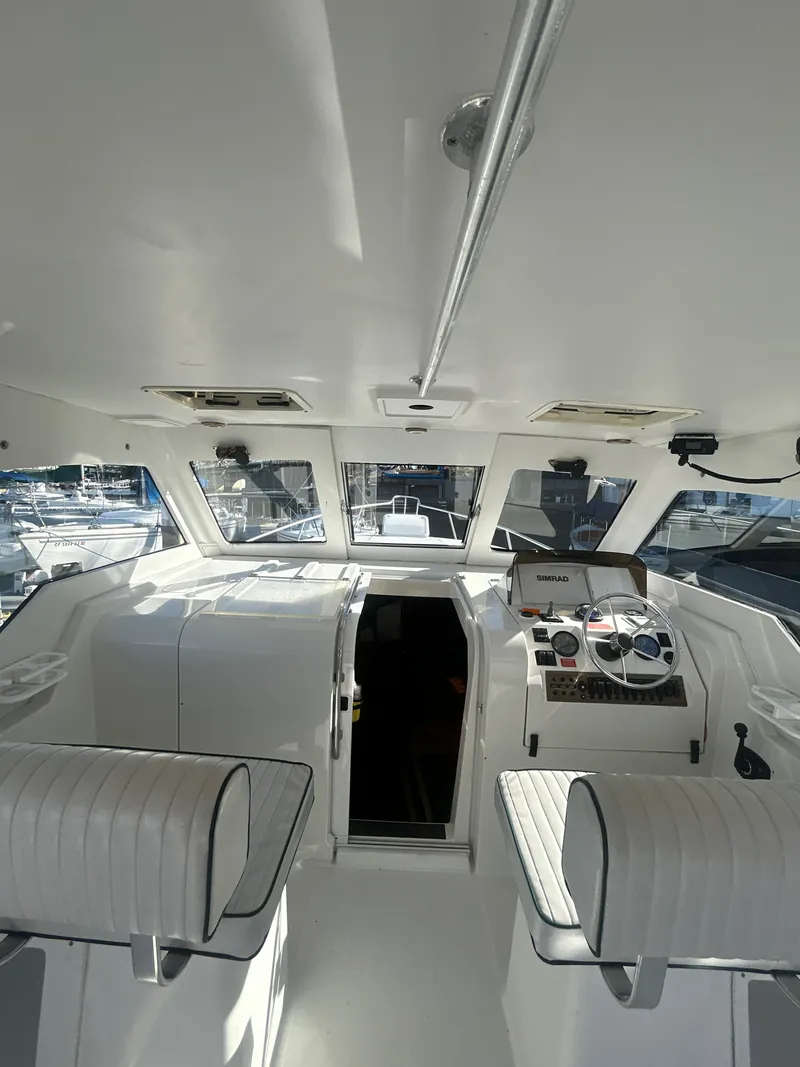 Slide: The Image of 2000 Mainship Pilot 34 boat interior with helm and seating. - 26