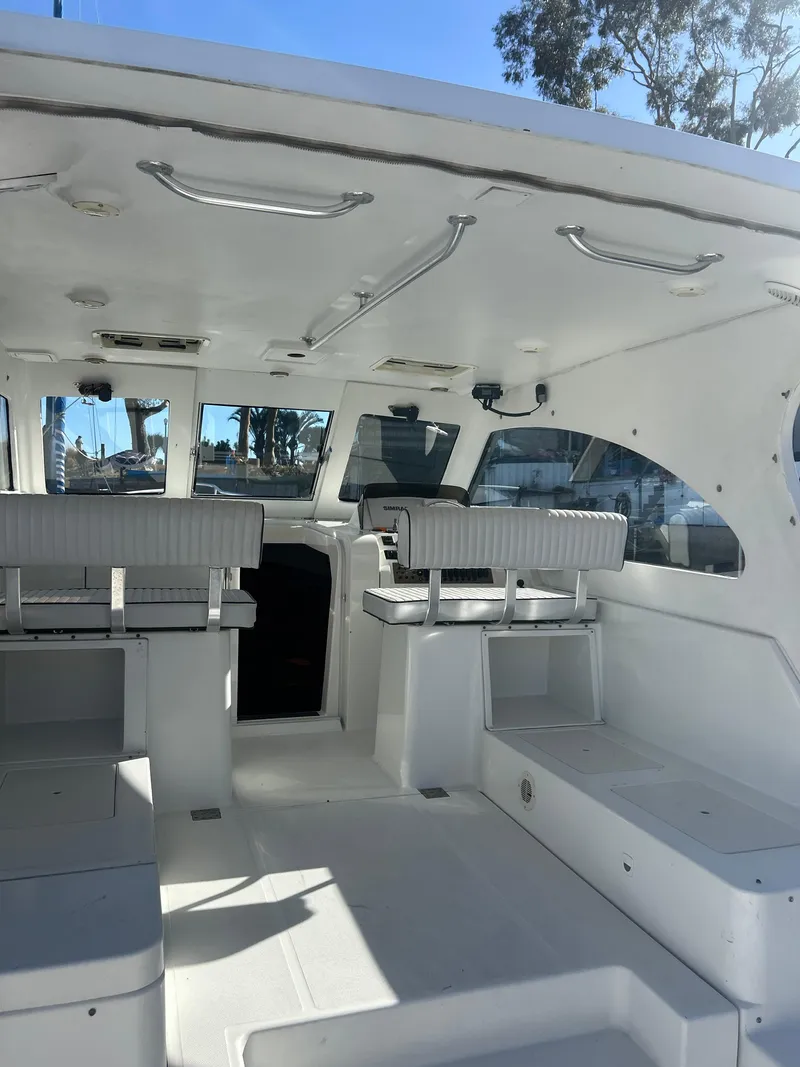 Slide: The Image of 2000 Mainship Pilot 34 interior with white seating and spacious layout. - 27