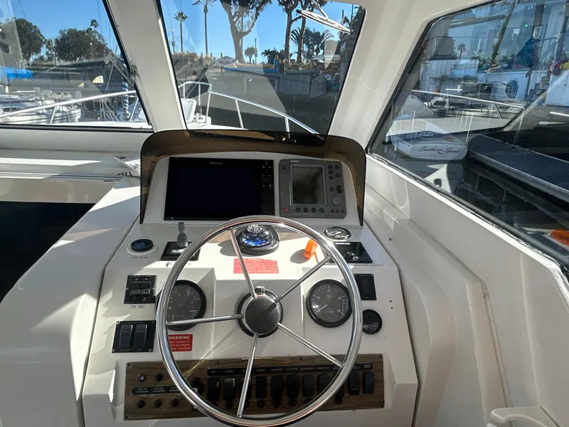 Slide: The Image of Cockpit of 2000 Mainship Pilot 34 boat with steering wheel and navigation instruments. - 8