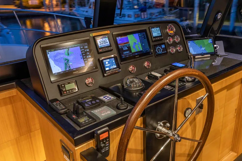 Slide: The Image of Pilothouse of 2021 North Pacific 49 Euro, featuring advanced navigation and control systems. - 13