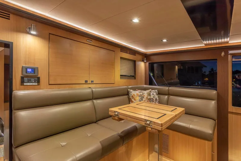 Slide: The Image of Luxurious interior of 2021 North Pacific 49 Euro Pilothouse with leather seating and wooden accents. - 14