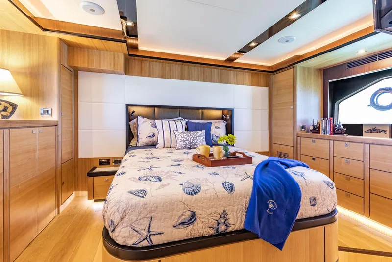 Slide: The Image of Luxurious bedroom in 2021 North Pacific 49 Euro Pilothouse yacht with nautical decor. - 18