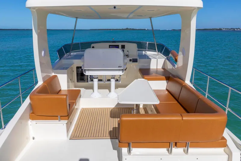 Slide: The Image of Luxurious 2021 North Pacific 49 Euro Pilothouse yacht interior with leather seating and ocean view. - 26