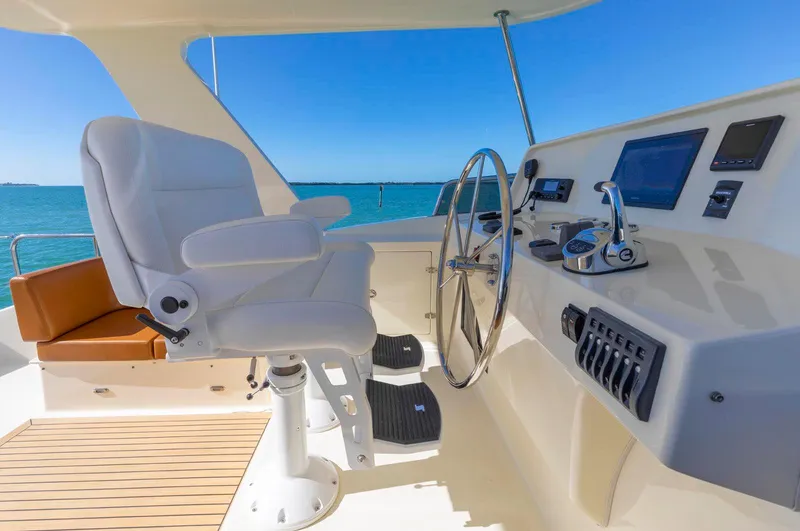 Slide: The Image of Luxurious helm of 2021 North Pacific 49 Euro Pilothouse with modern controls and ocean view. - 31