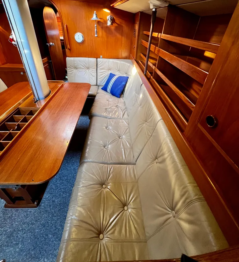 Slide: The Image of Interior of 1984 Nautor Swan 391 yacht with plush seating and wooden finishes. - 13