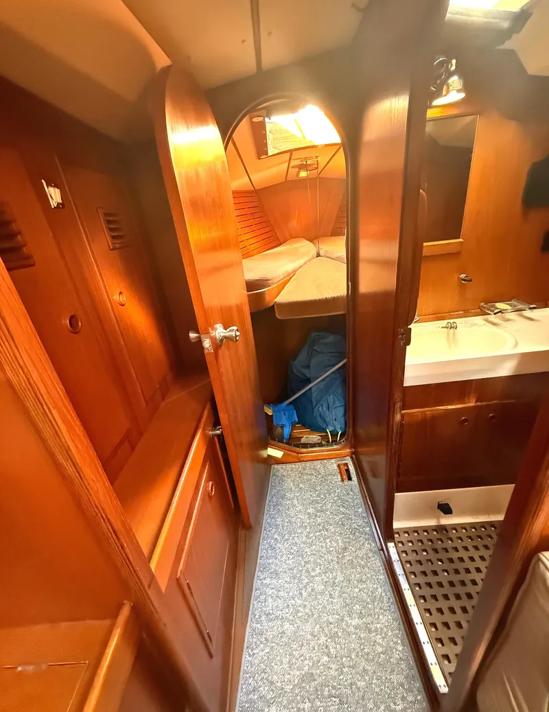 Slide: The Image of Interior of 1984 Nautor Swan 391 yacht, featuring wooden cabinetry and cozy sleeping quarters. - 19