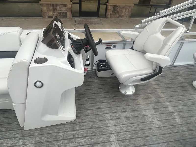 Slide: The Image of 2022 Avalon 2080 VENTURE FNC boat interior with steering console and captain's chair. - 14
