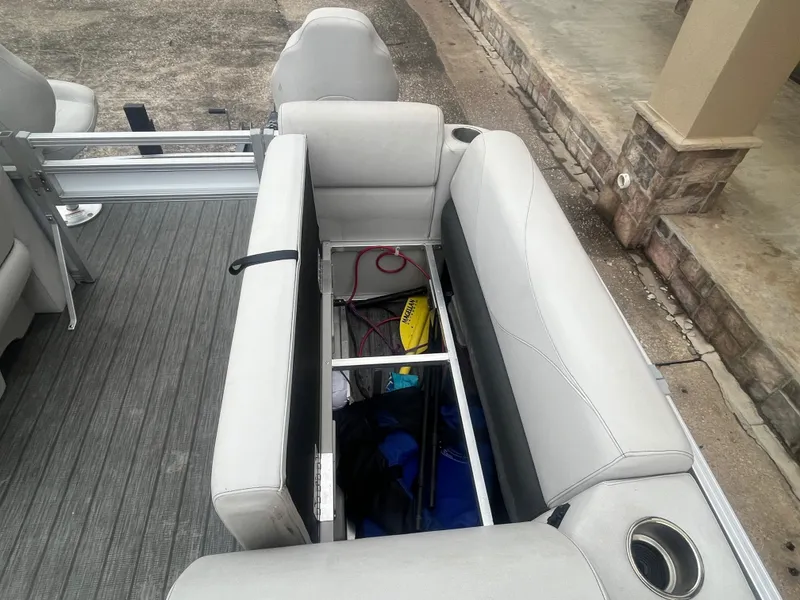 Slide: The Image of Open storage compartment in 2022 Avalon 2080 VENTURE FNC boat with visible items inside. - 18