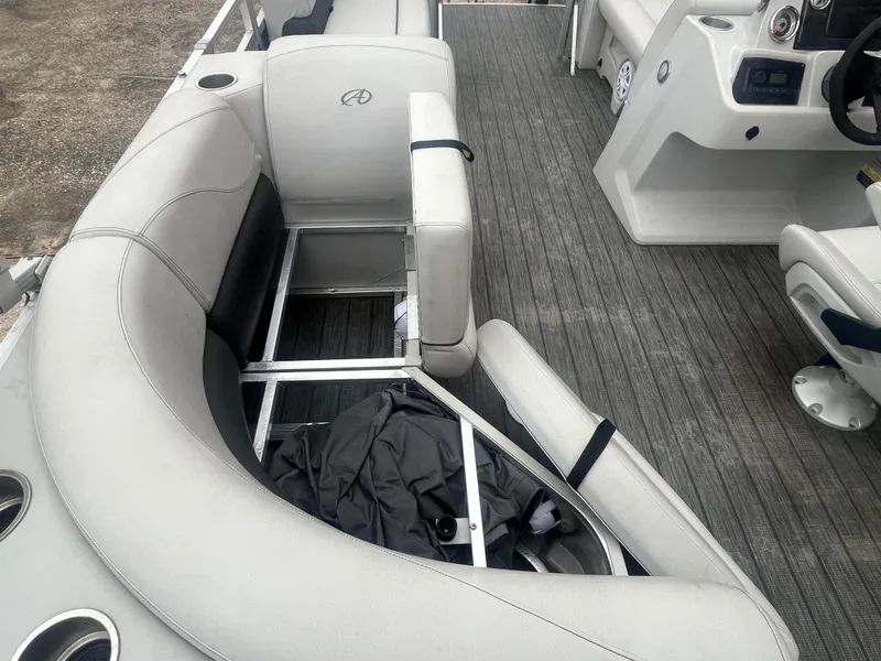 Slide: The Image of 2022 Avalon 2080 VENTURE FNC boat interior with gray seating and storage compartment. - 20