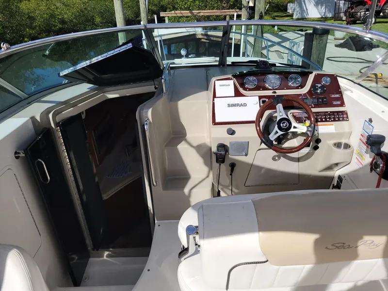 Slide: The Image of 2010 Sea Ray 280 Sundancer cockpit with steering wheel and control panel. - 10