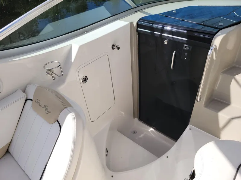 Slide: The Image of 2010 Sea Ray 280 Sundancer interior with seating and cabin door. - 12