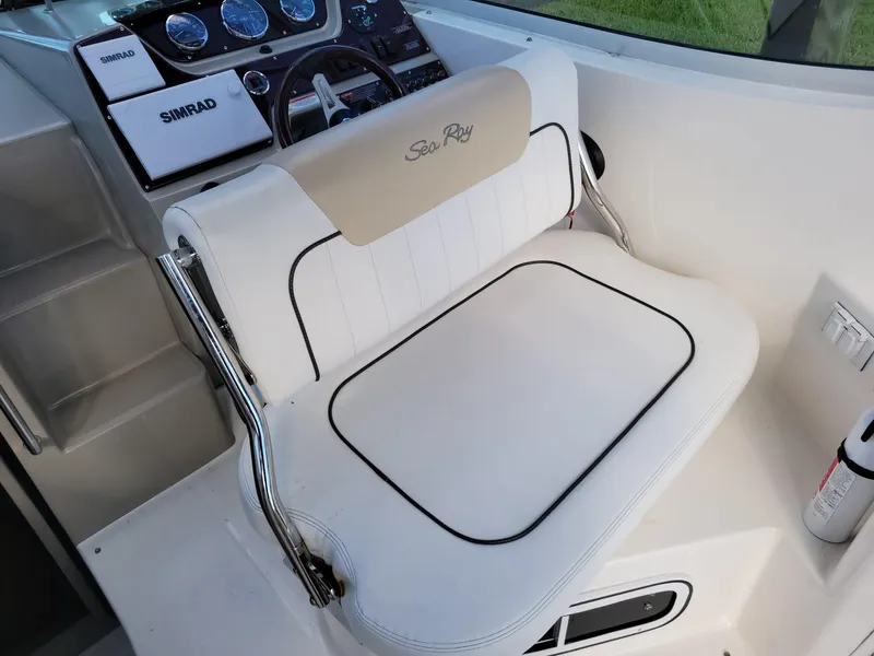 Slide: The Image of Captain's seat on 2010 Sea Ray 280 Sundancer boat, featuring Simrad navigation system. - 13