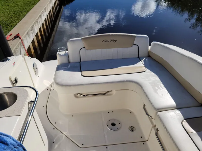 Slide: The Image of 2010 Sea Ray 280 Sundancer boat interior with seating and water view. - 14