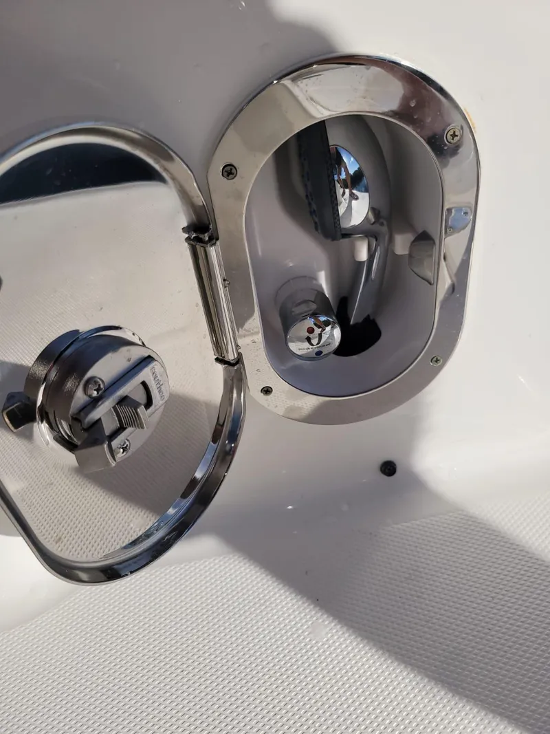 Slide: The Image of 2010 Sea Ray 280 Sundancer fuel cap and compartment detail. - 17