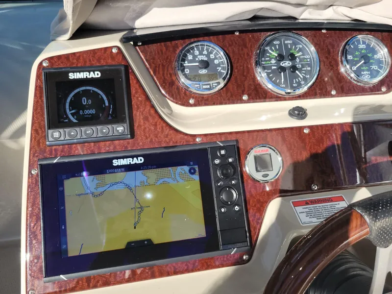 Slide: The Image of Dashboard of 2010 Sea Ray 280 Sundancer with Simrad navigation system and gauges. - 18