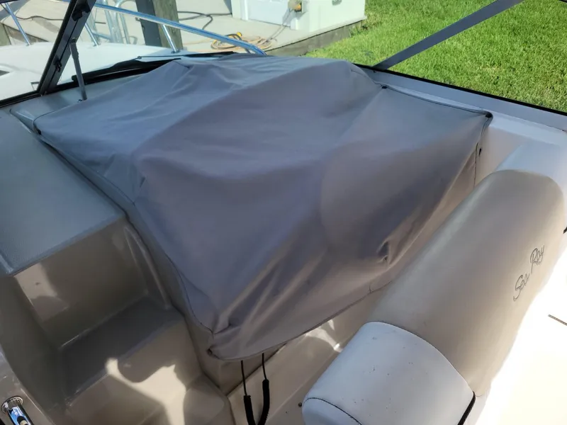Slide: The Image of 2010 Sea Ray 280 Sundancer cockpit with protective cover and seating. - 20