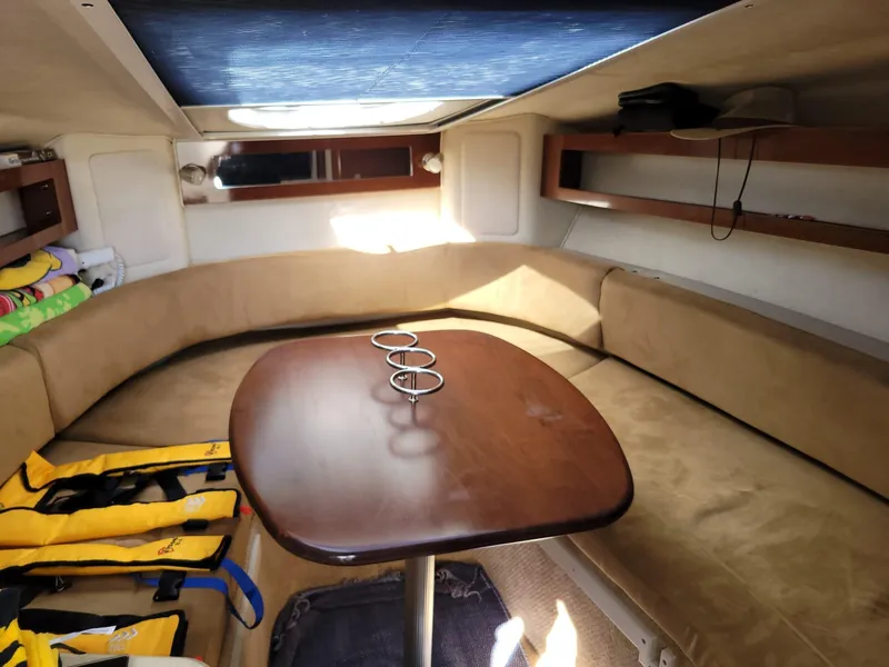 Slide: The Image of 2010 Sea Ray 280 Sundancer cabin interior with table and seating. - 30