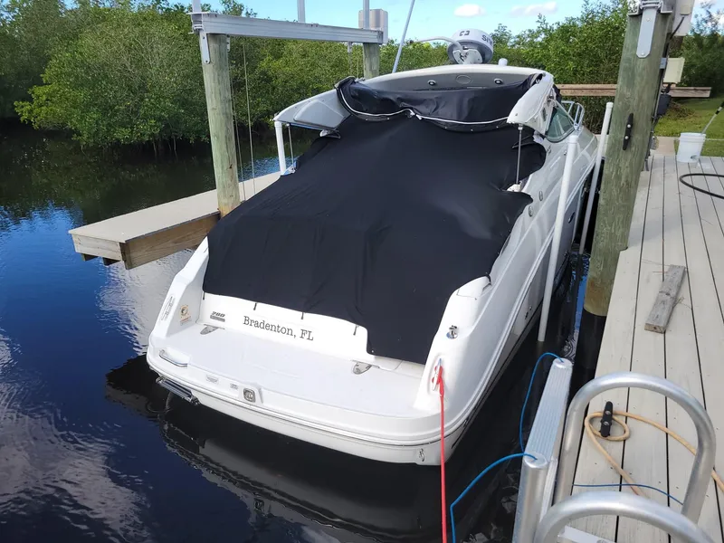 Slide: The Image of 2010 Sea Ray 280 Sundancer docked in Bradenton, FL, covered with a black tarp. - 6