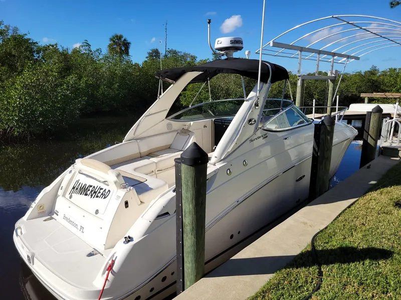 Slide: The Image of 2010 Sea Ray 280 Sundancer docked by lush greenery. - 7
