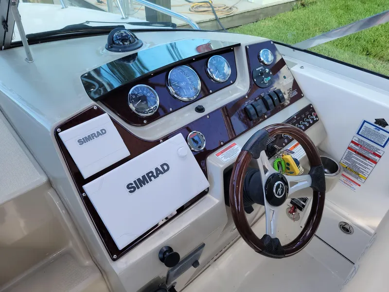 Slide: The Image of Dashboard of a 2010 Sea Ray 280 Sundancer boat with Simrad navigation system. - 9