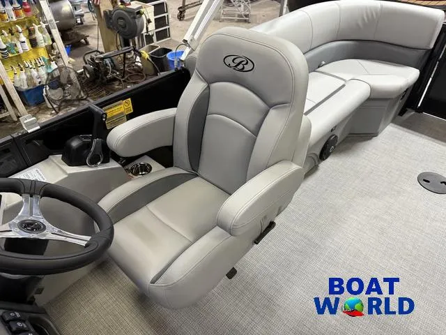 Slide: The Image of 2025 Bentley Pontoons Legacy 200 Navigator interior with plush seating and steering wheel. - 13