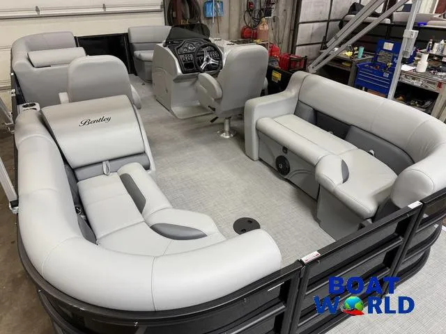 Slide: The Image of 2025 Bentley Pontoons Legacy 200 Navigator Quad Lounge interior with plush seating and modern dashboard. - 21