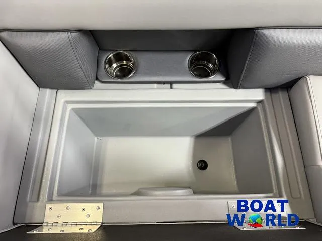 Slide: The Image of 2025 Bentley Pontoons Legacy 200 Navigator Quad Lounge interior with cup holders and storage compartment. - 26